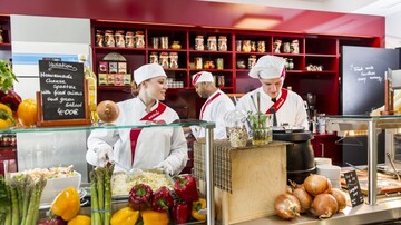 Three sodexo chefs standing in front of a counter