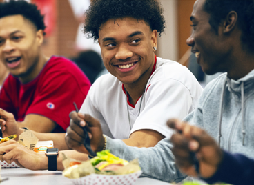 Male student laughing in school cafeteria