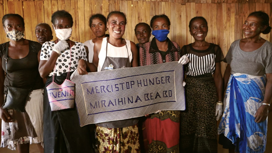 Women holding a banner to thank Stop Hunger