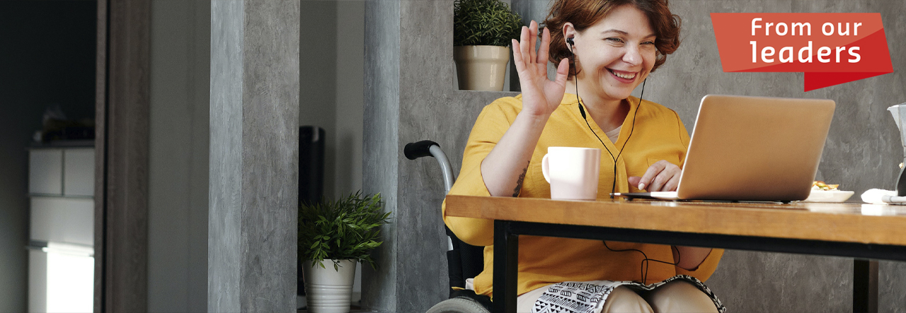 woman in wheelchair sitting at a desk, text reads: from our leaders