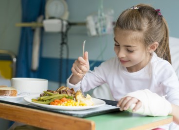 A young patient enjoying a hospital meal