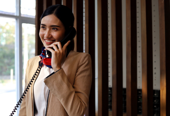 Receptionist talking on the phone smiling