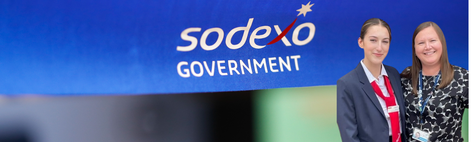 mom and daughter together in front of the Sodexo Government's logo