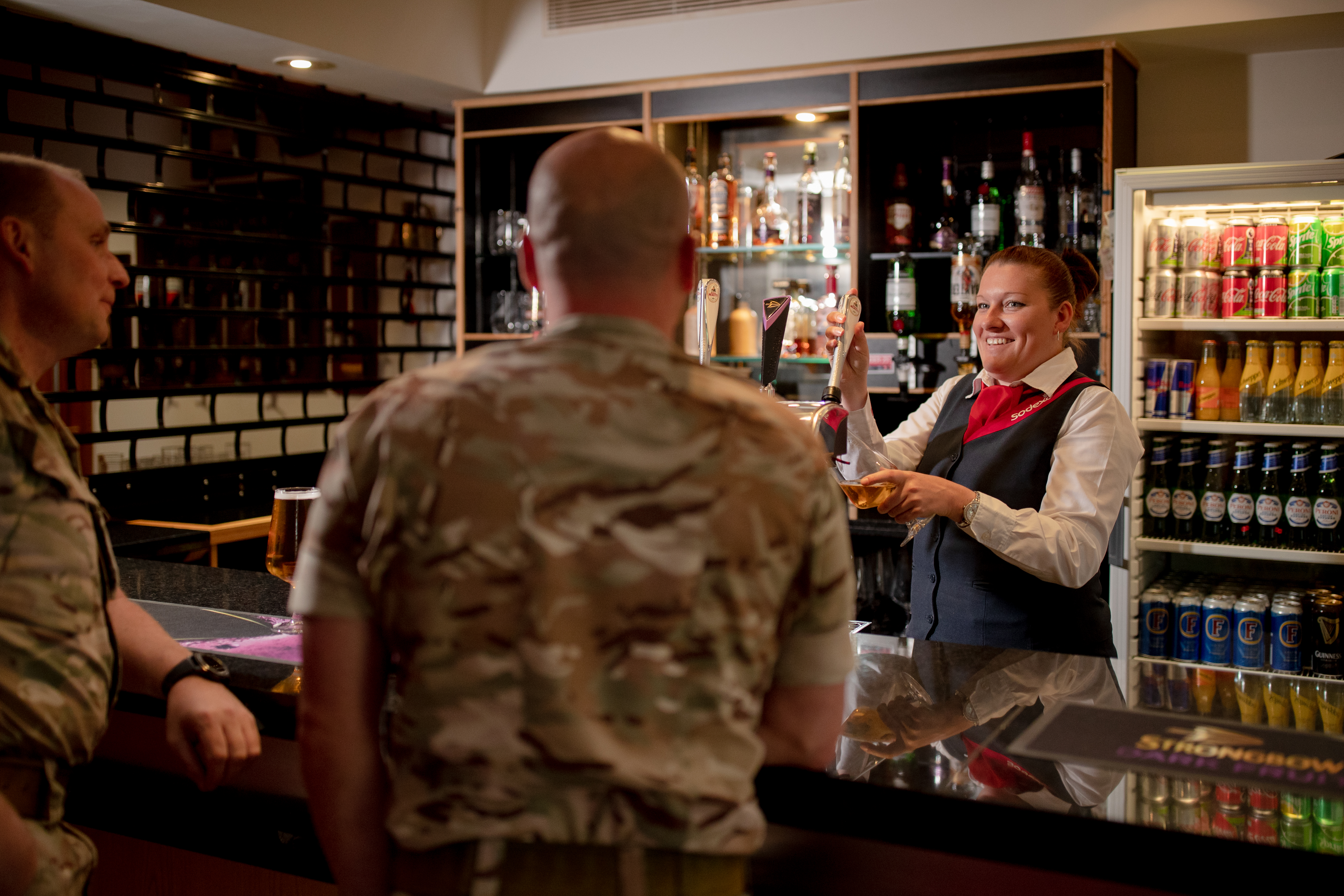 bartender preparing drinks for soldiers 