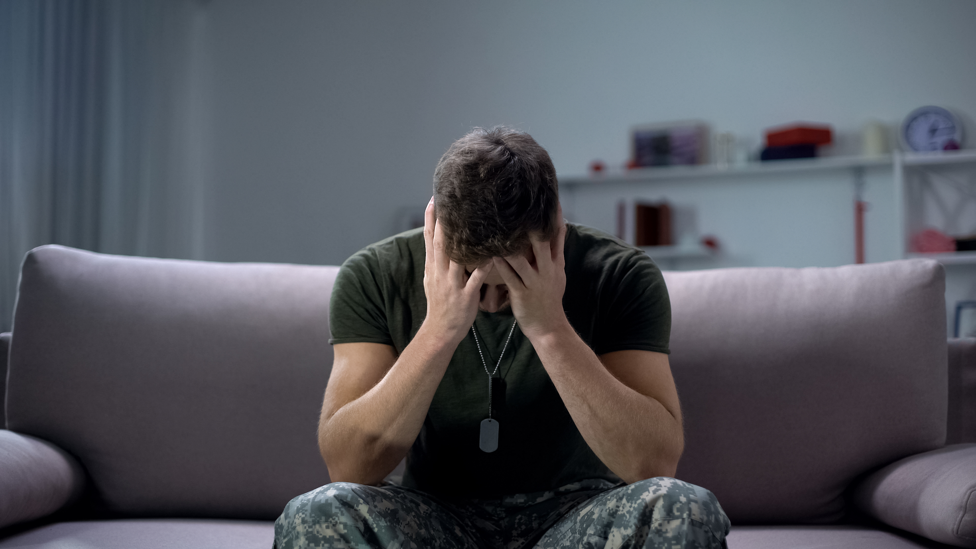 soldier sitting on the couch feeling frustrated 