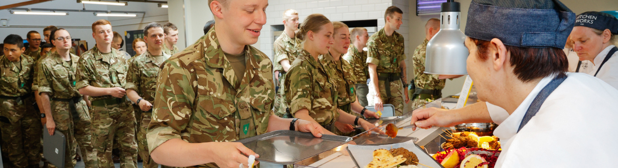 military personnel getting food on a buffet