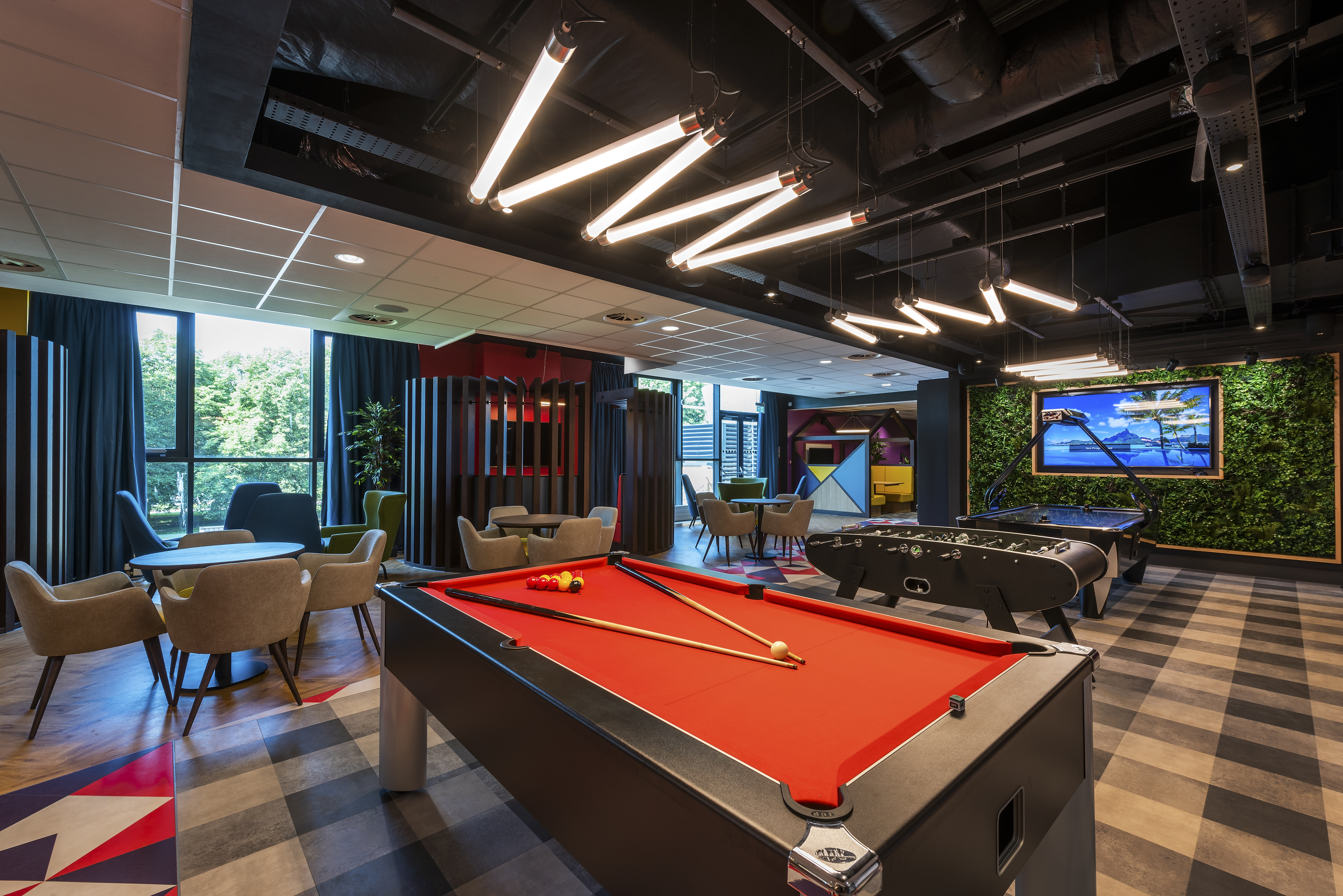 Gaming area with a mix of board games, pool and table tennis