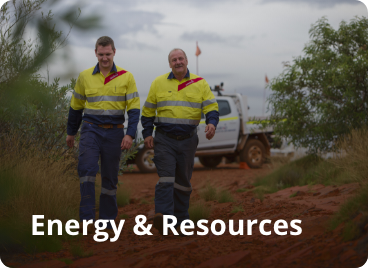 Two workers walking side by side on a remote site. Text on the image says Energy &amp; Resources
