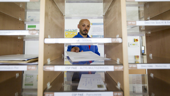 Sodexo employee putting an item of mail in a pigeon hole