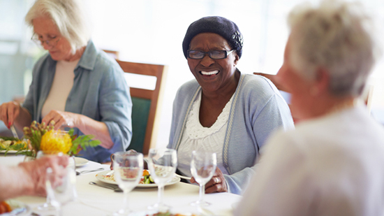 Three senior women eating a meal