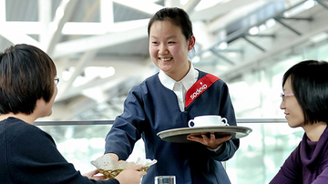 Woman serving hot drinks
