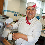 kitchen staff member preparing milk
