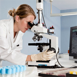 Scientist looking into microscope